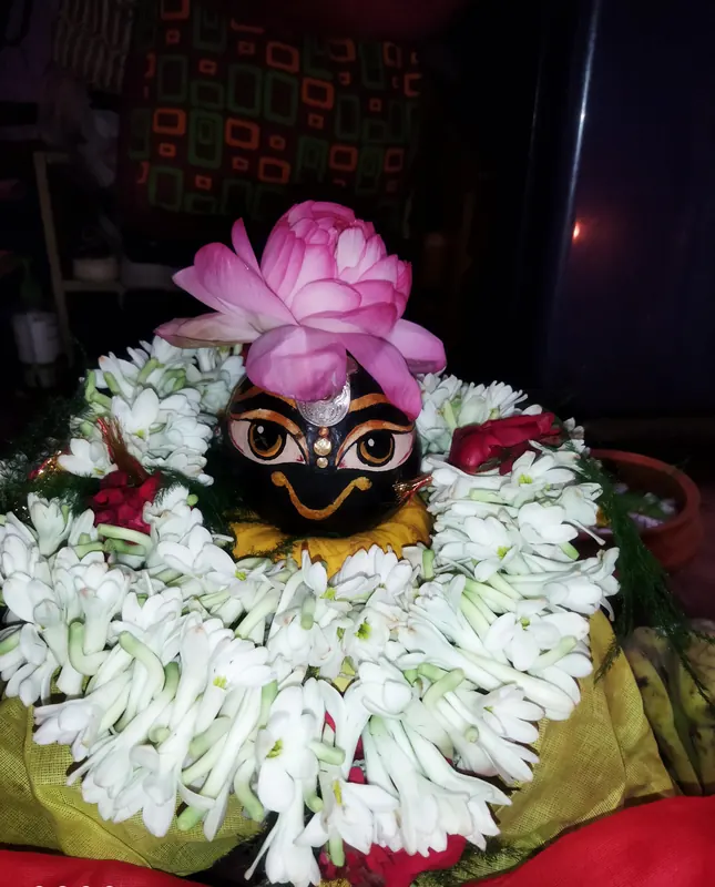 Decorated deity during puja